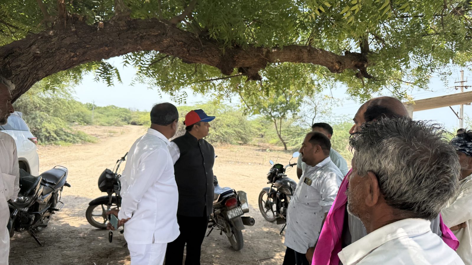 HyperNext team members reviewing the project site with members of the local community