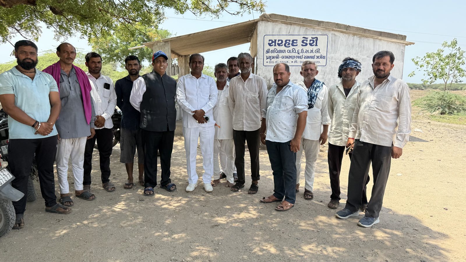 The project team standing with members of the local dairy cooperative at the Nagmati site